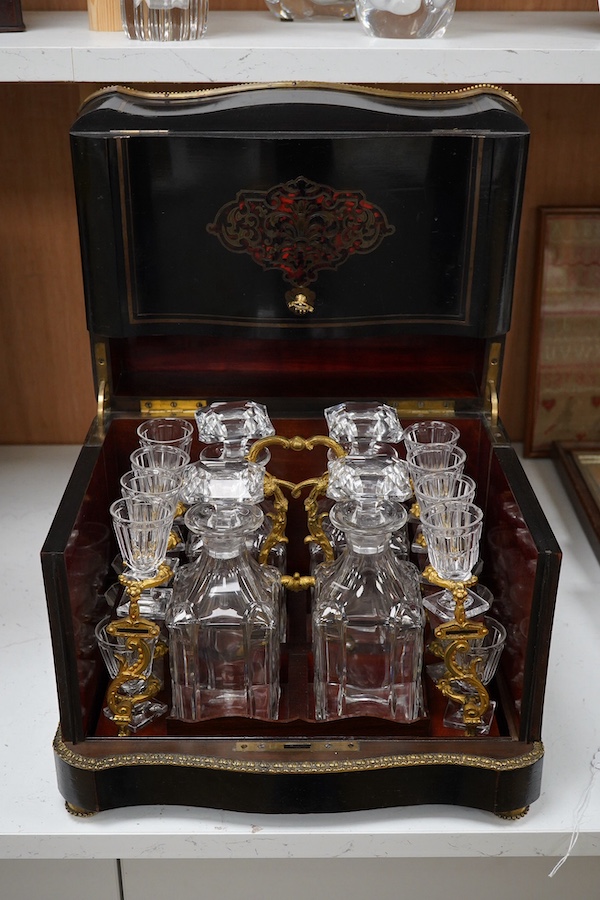 A 19th century Boulle panelled and decorative brass work liqueur cabinet, the interior fitted with gilt fitments, four cut glass decanters and sixteen liqueur glasses, 34cm wide, 26cm high. Condition - minor scratches to